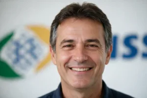 homem-maduro-sorrindo-com-logo-do-inss-atras.png.webp
